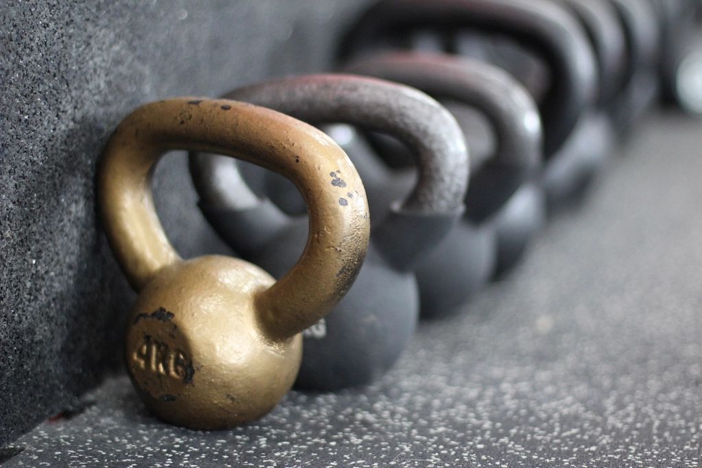 Row of kettlebells on a rubber gym floor